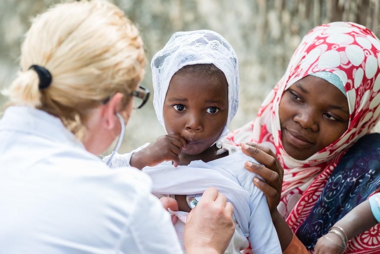Healthcare worker with African child 
