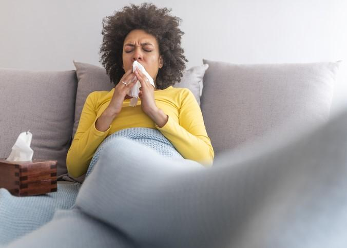 Woman with flu on couch