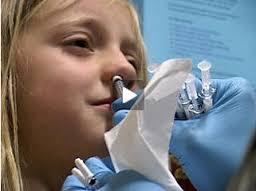 Young girl receiving nasal flu mist