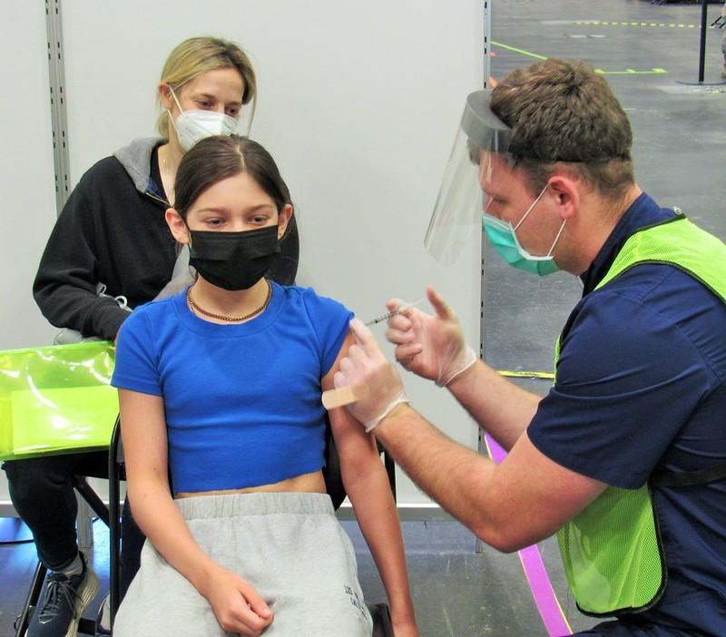 Girl getting COVID vaccine
