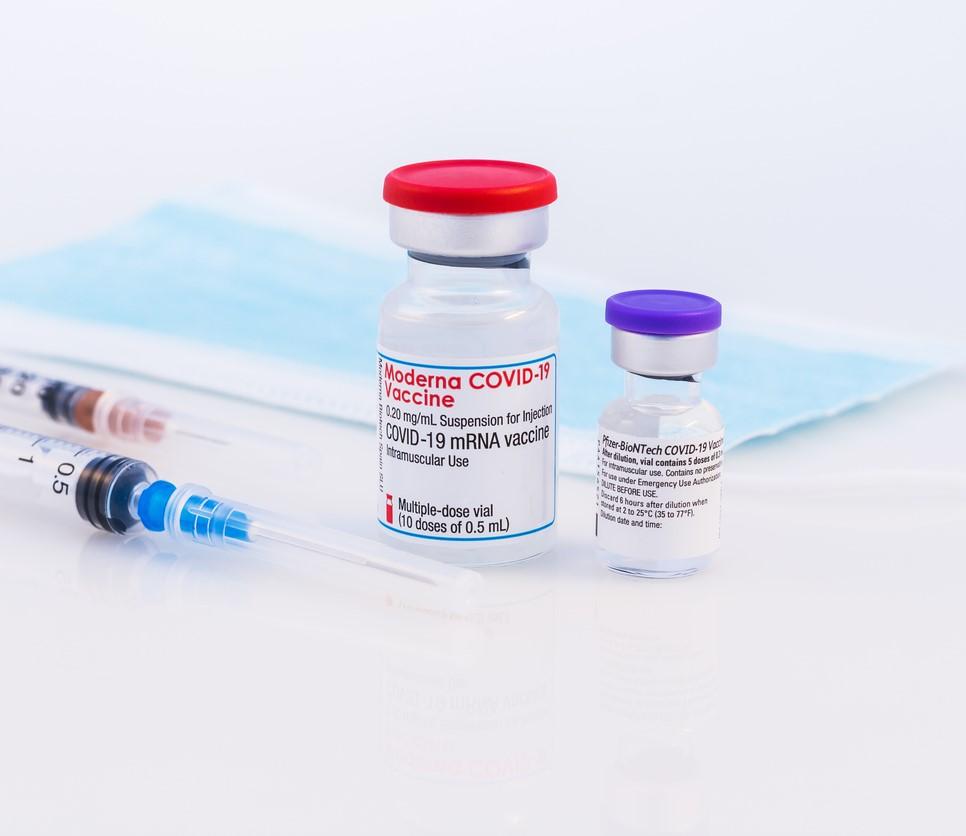 Vials of Moderna and Pfizer COVID vaccine side by side