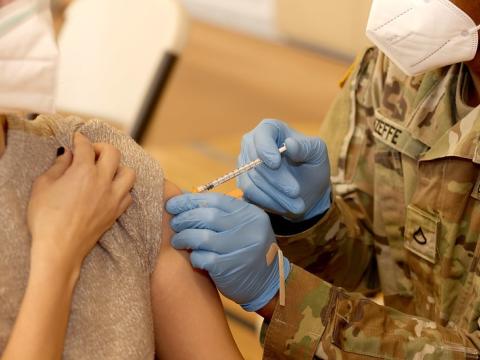 Army personnel giving COVID vaccination
