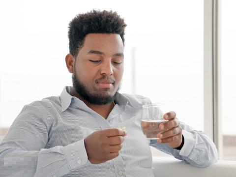 Man taking oral pill