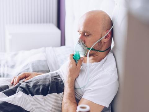 Man with oxygen mask in hospital