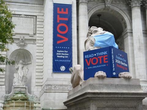 NY library mask on statue vote signs