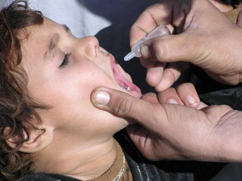 Child receiving oral polio vaccine