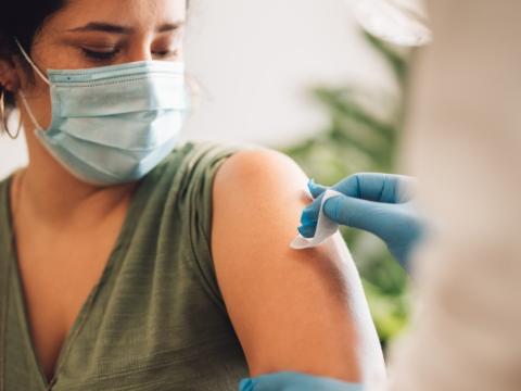 Woman getting prepped for vaccine in arm