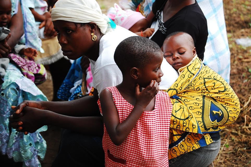 Woman with child in wrap on her back