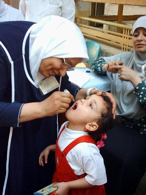 Child taking oral polio vaccine