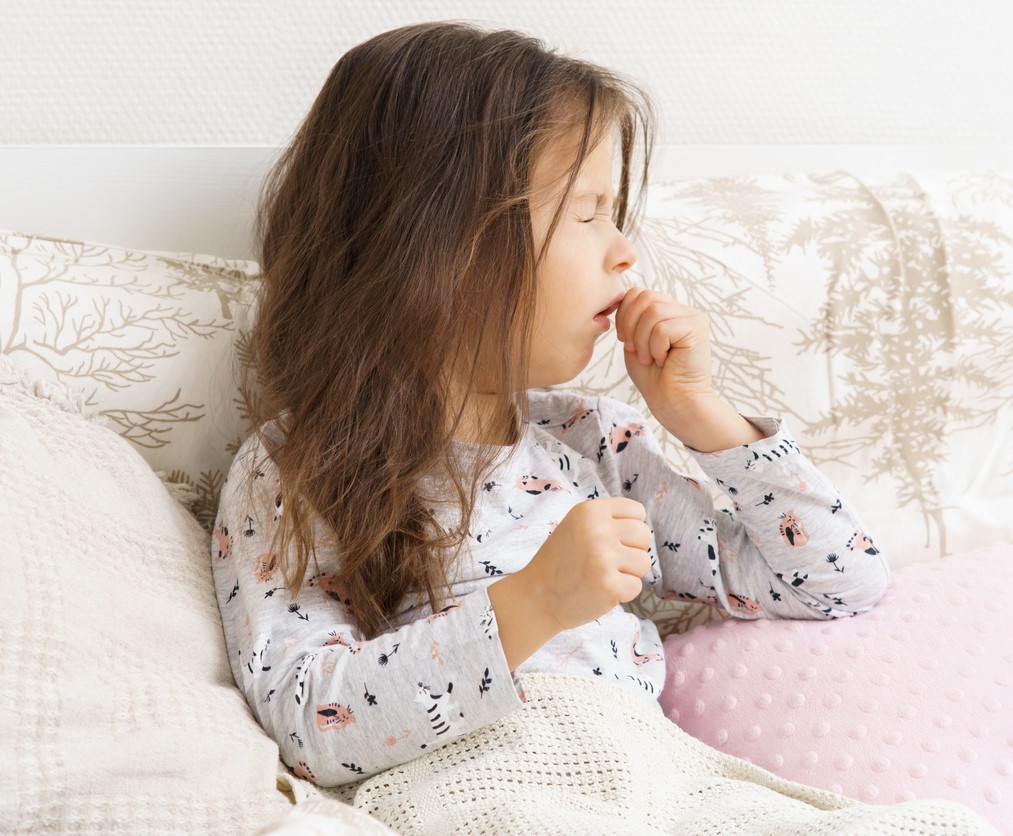 Coughing girl in bed