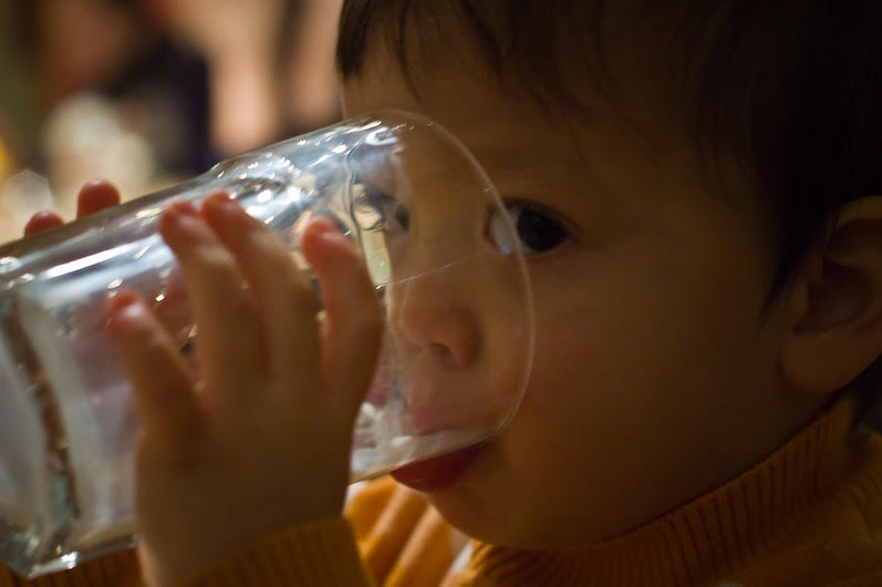 Little boy drinking glass of milk