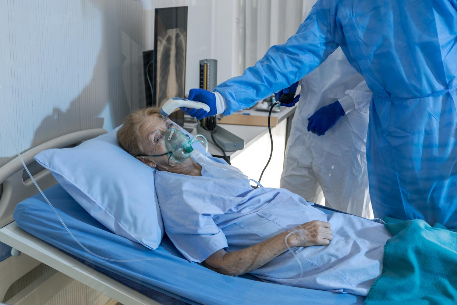 Older woman in hospital with oxygen mask