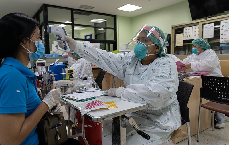 Healthcare worker taking temperature