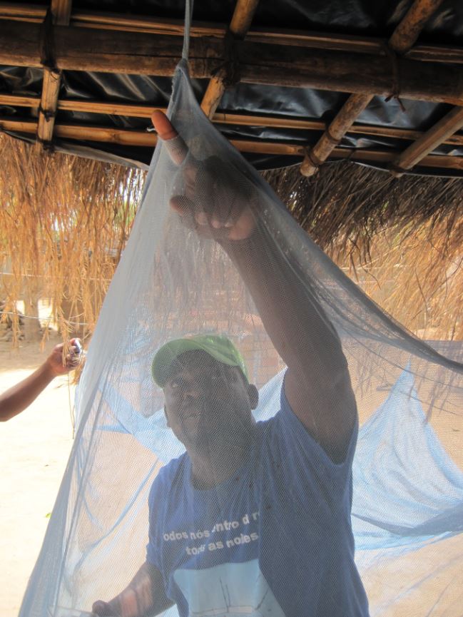 Man hanging mosquito netting
