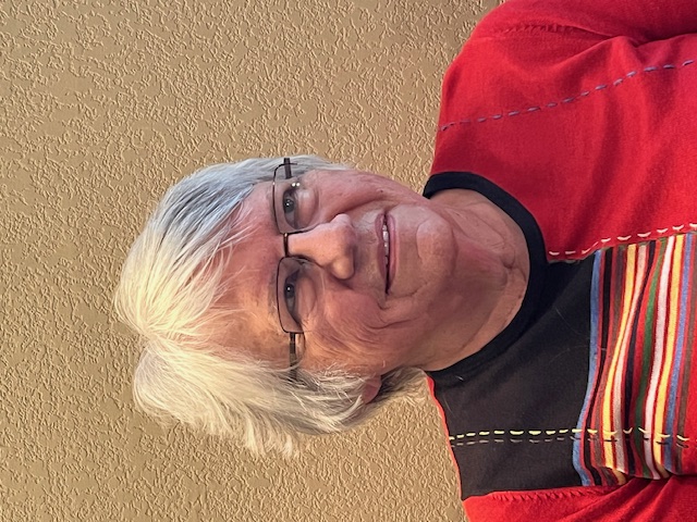 A woman with short silver hair.