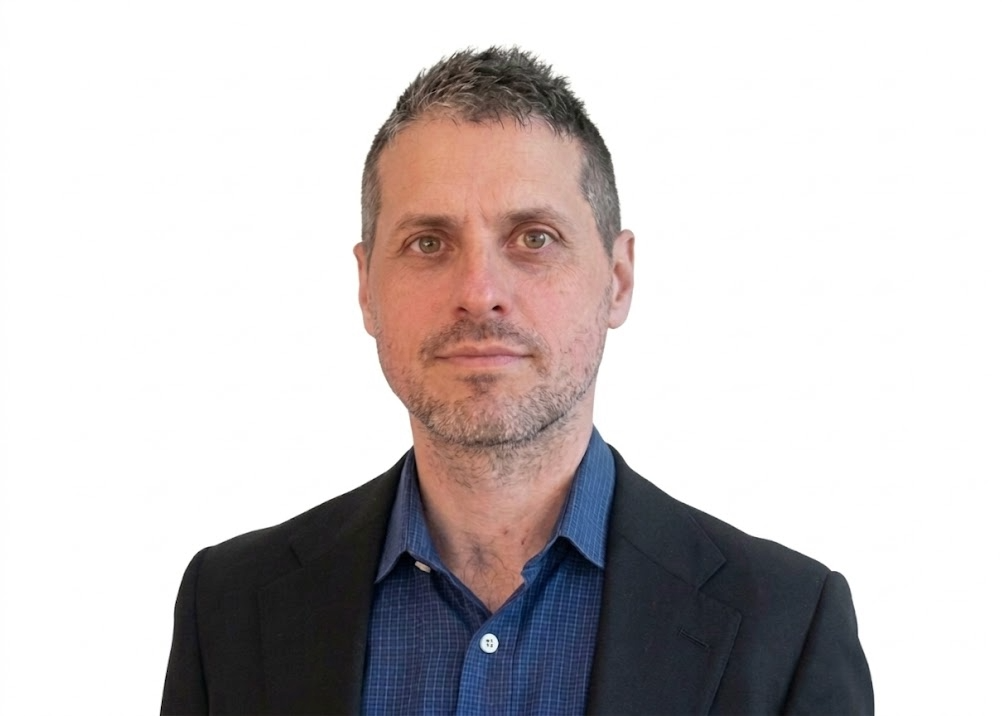 A headshot of Michael Mina, MD, PhD
