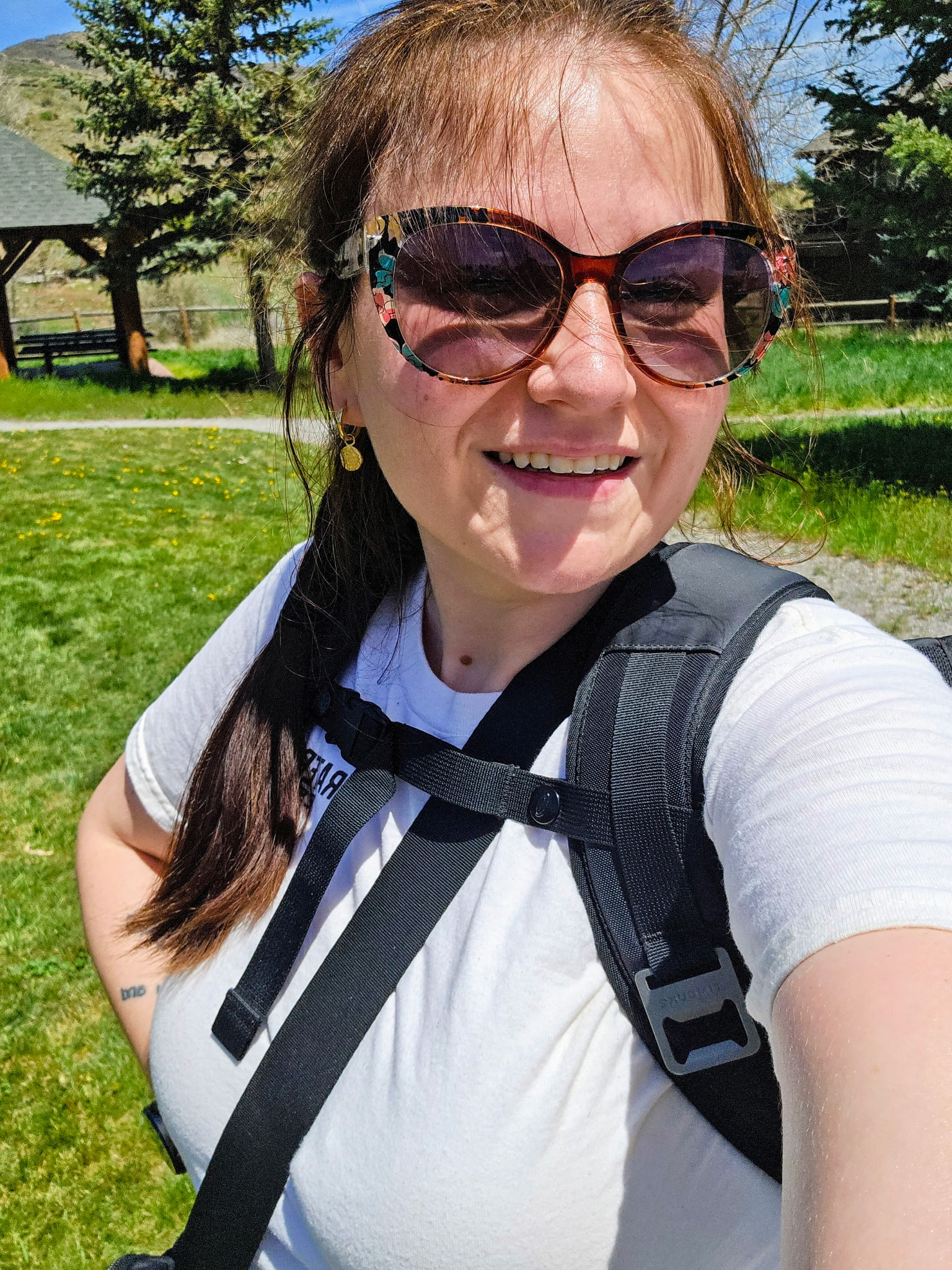 White woman wearing sunglasses outside