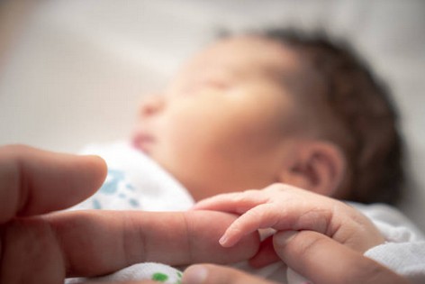 Baby grasping finger