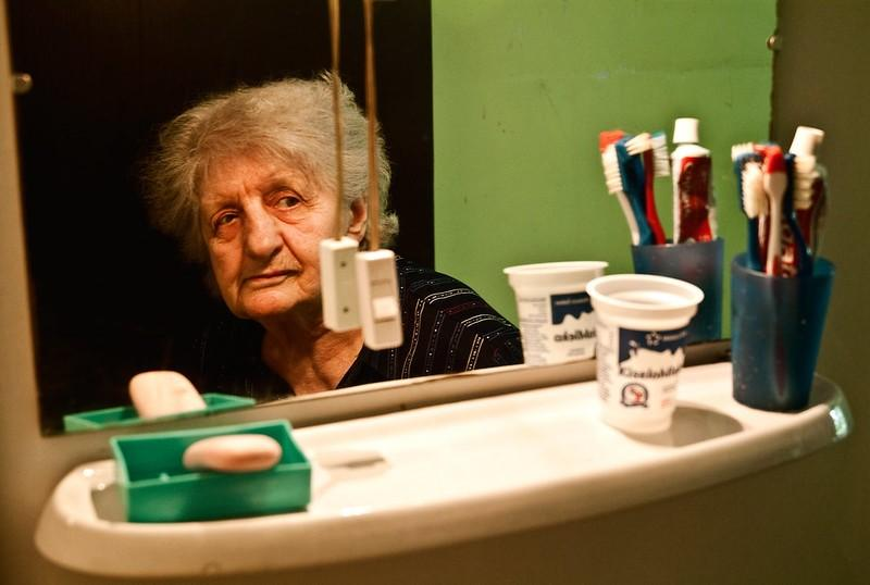 Older woman looking into mirror