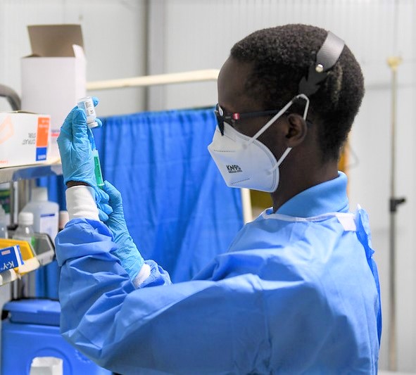 Healthcare worker preparing a COVID booster