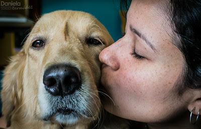 Woman kissing dog