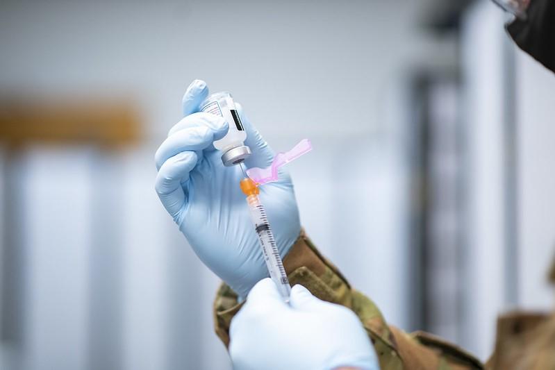 Drawing COVID vaccine into syringe