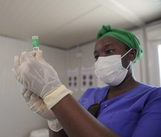 Healthcare worker drawing up syringe