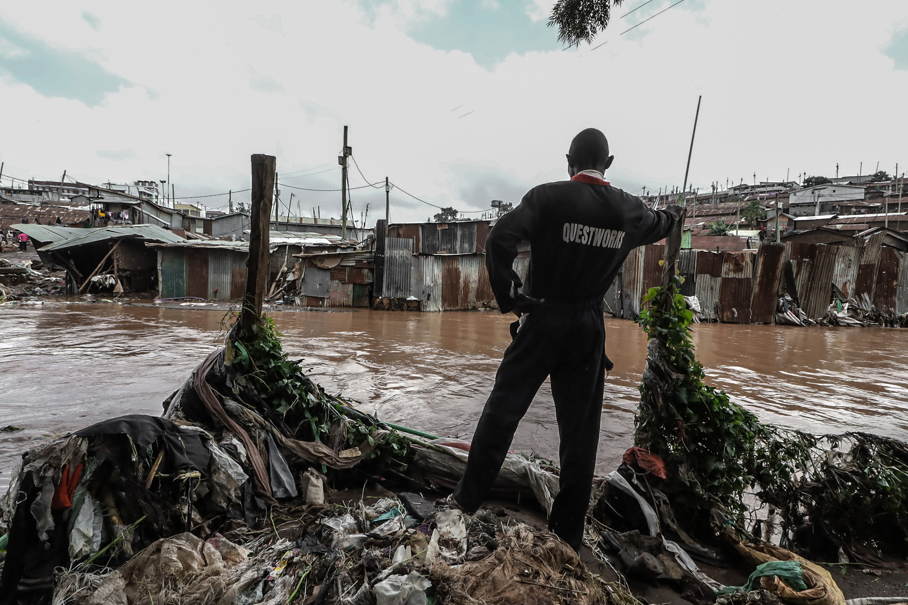 David Odhiambo stands outside his house damaged after the heavy flooding. May 13, 2021 in Kibera, Nairobi, Kenya