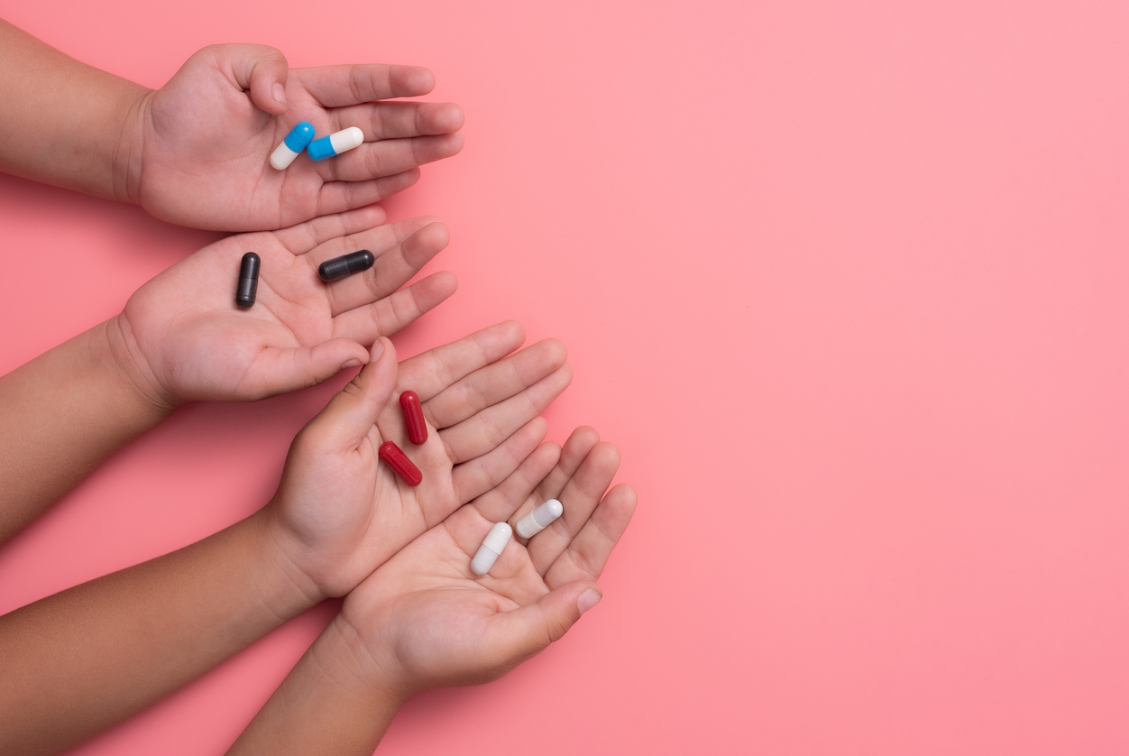Pills in hands of children