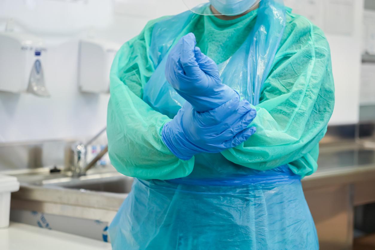 Health care worker in gloves and gown