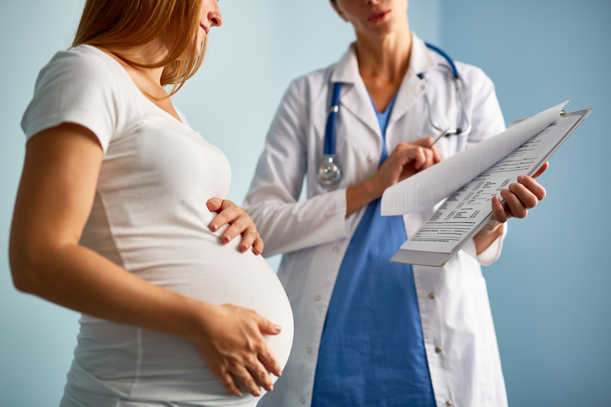 Pregnant woman talking with doctor