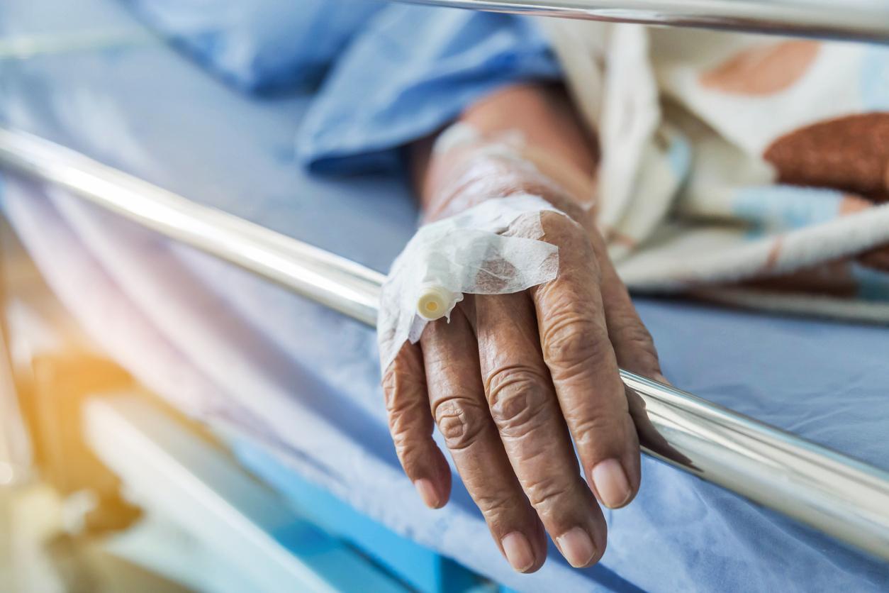 Patient hand on bed rail