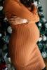 Pregnant woman in front of Christmas tree