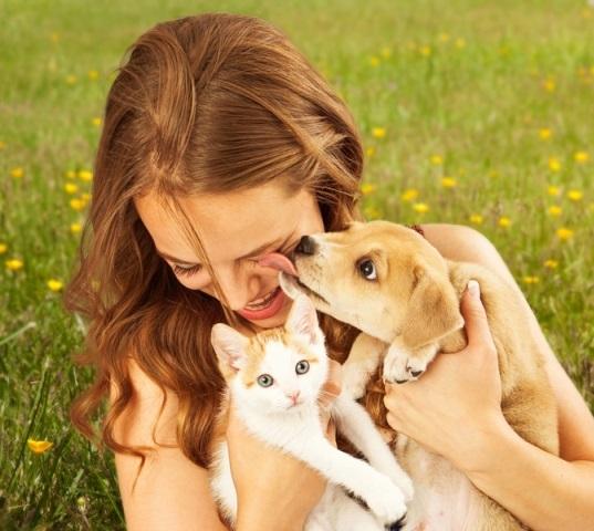 Woman with puppy and kitten