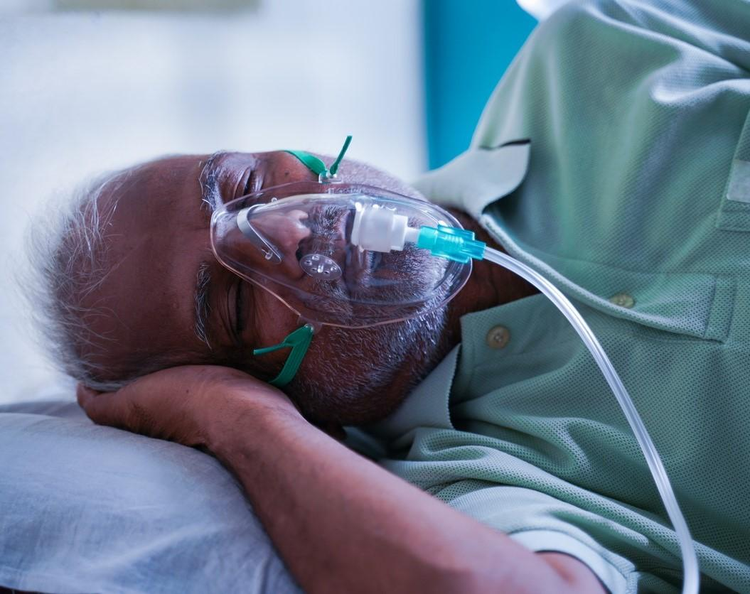 Sleeping man with oxygen mask