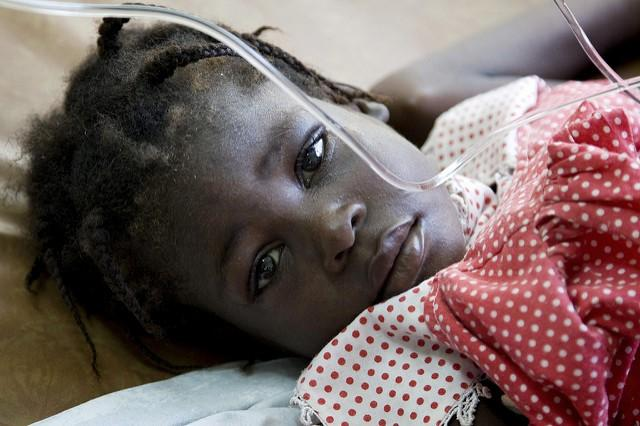 Girl lying in bed in Africa