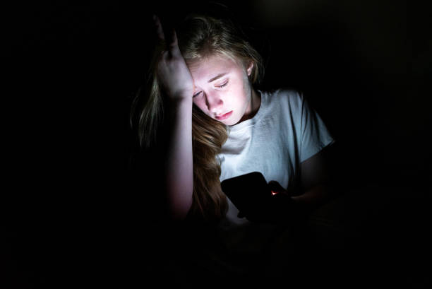 Anxious girl looking at phone