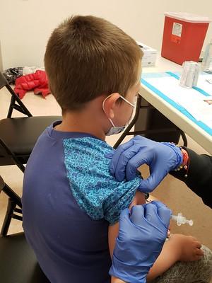 Boy receiving COVID vaccination
