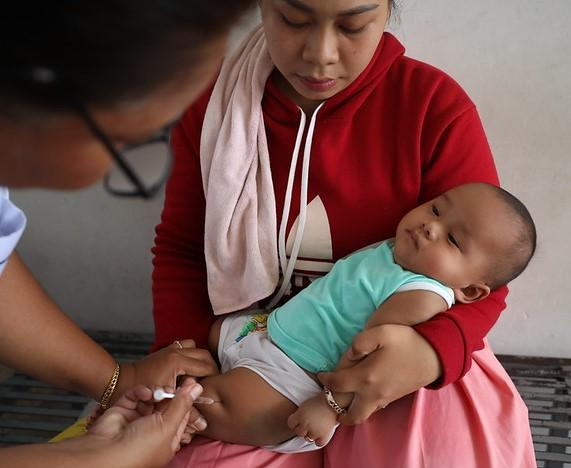 Baby being immunization against RSV in thigh