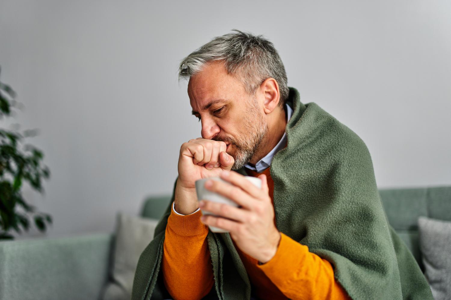 Ill middle-aged man on couch