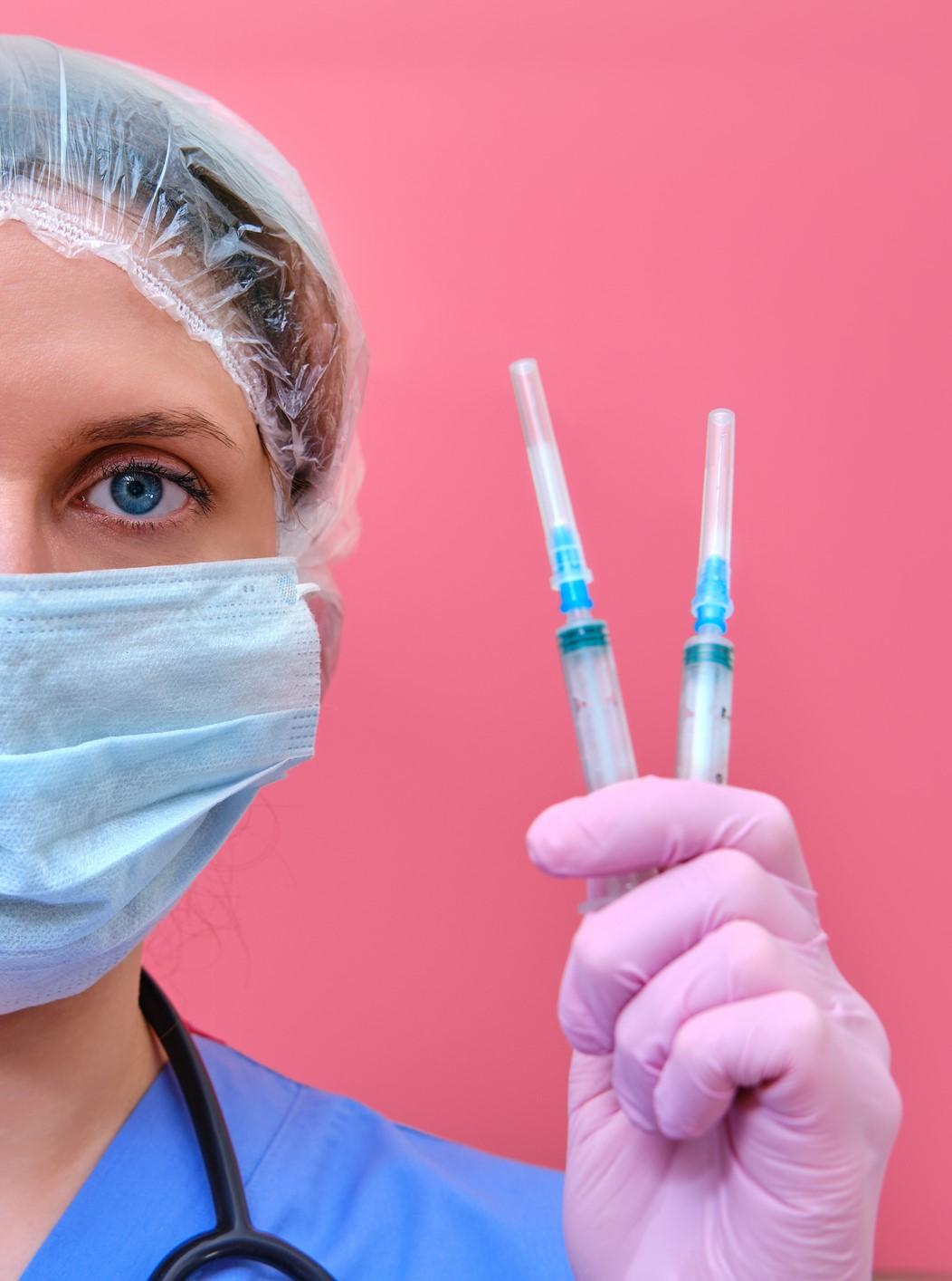 Doctor holding insulin syringes