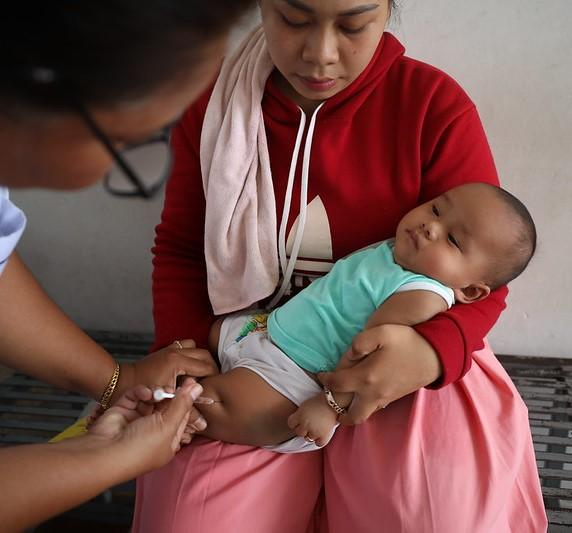 Giving childhood vaccine