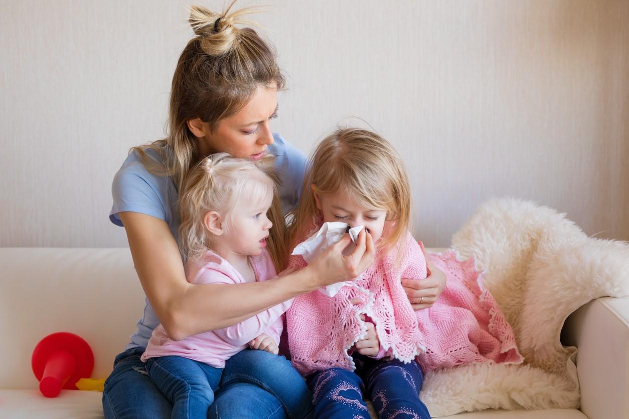 Mom with sick girl on couch