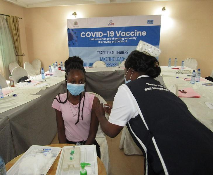 Nurse vaccinating girl in Africa