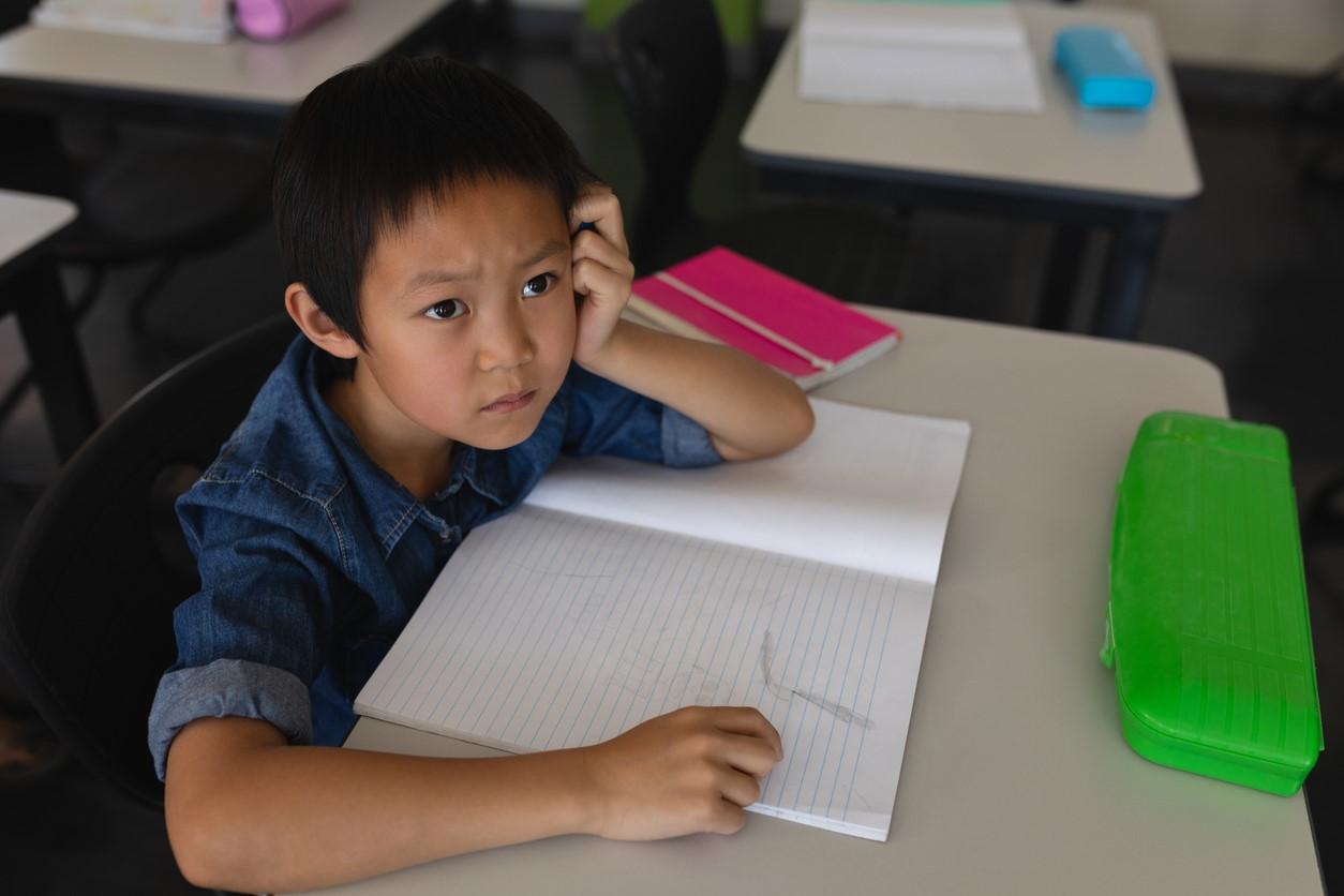 Puzzled young student at desk