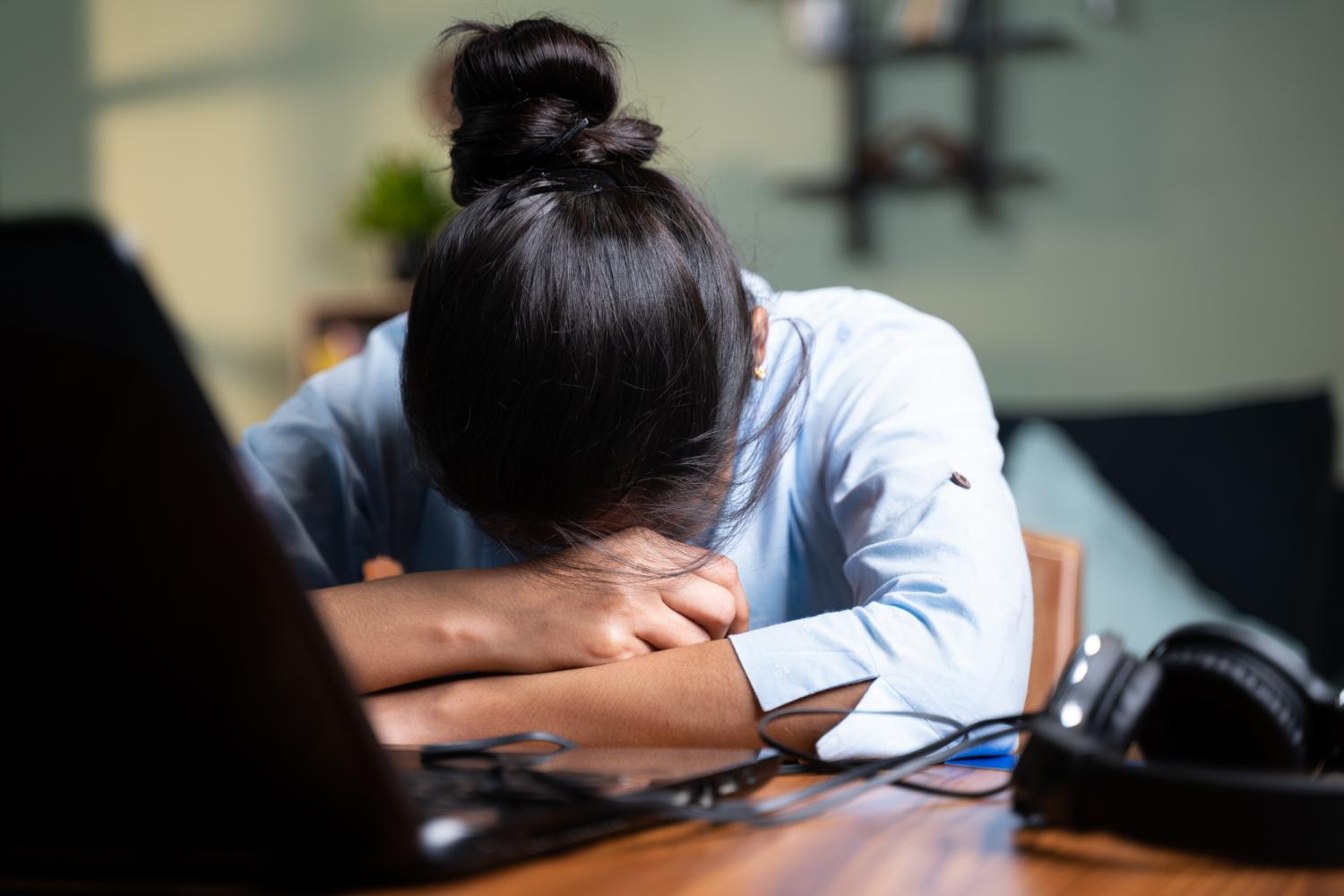 Sleeping Asian woman at desk