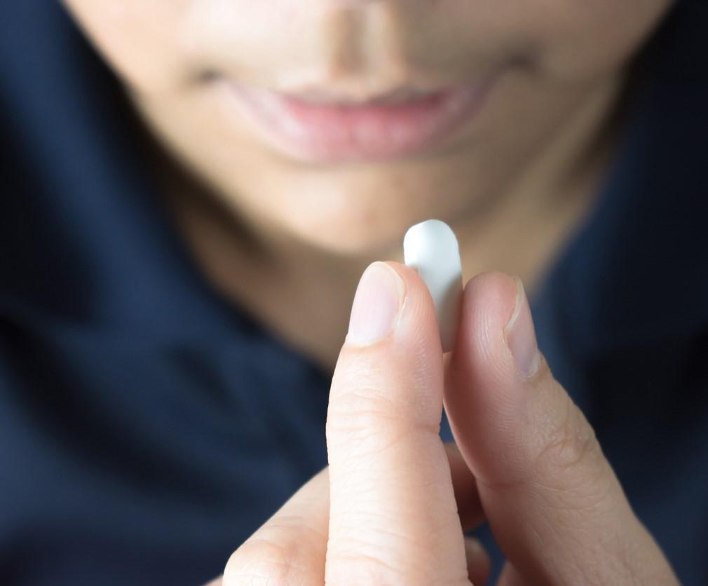Woman taking pill