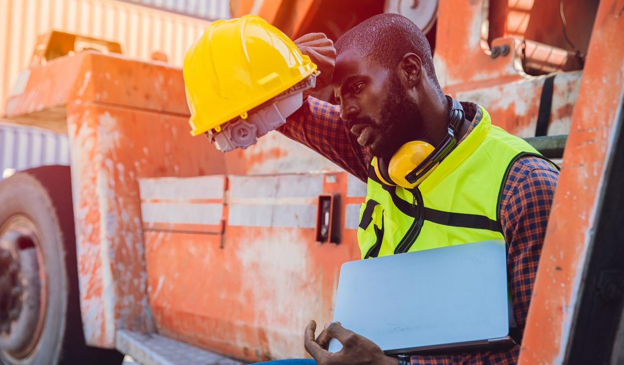 Tired worker with hardhat