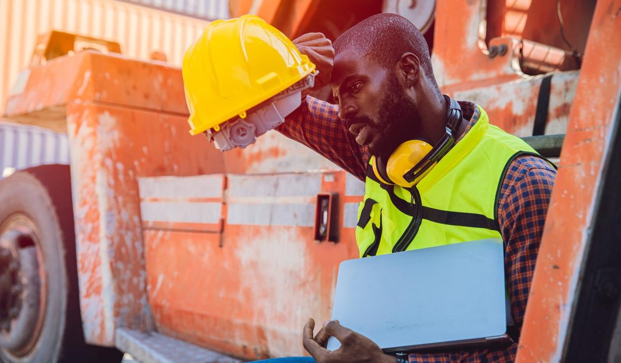 Tired worker with hardhat