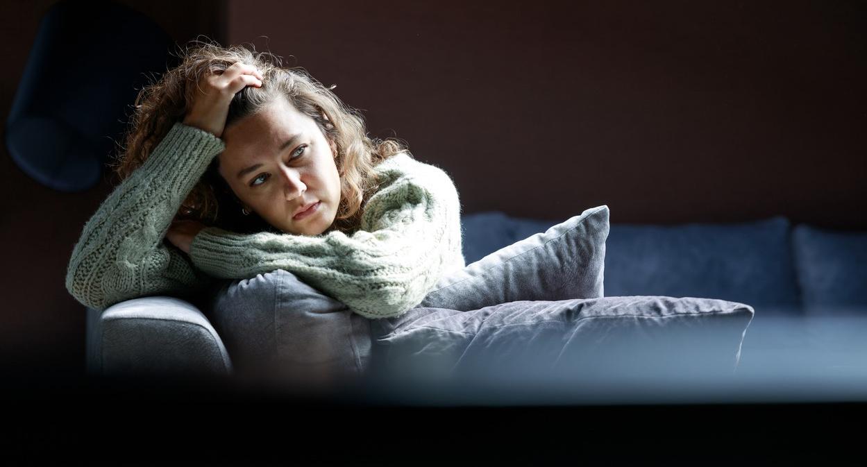 Tired young woman on sofa